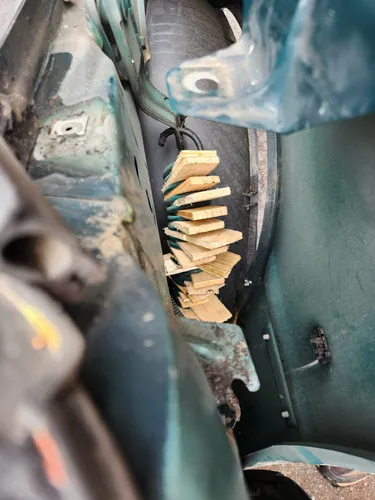 Driver-side spring with shims